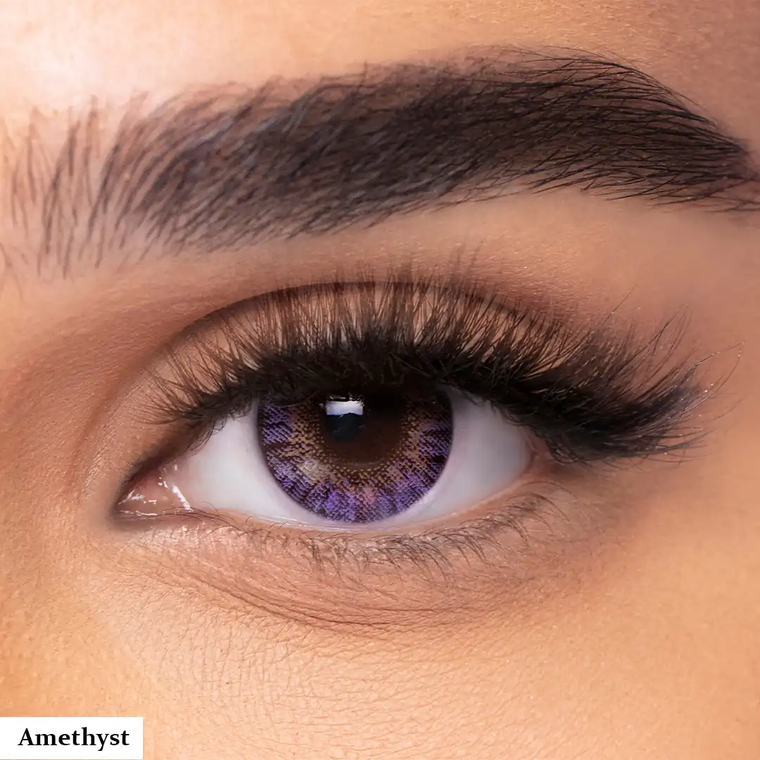 A model wearing Freshlook Amethyst Fashion Purple Violet Coloured Contact Lenses, close-up view of the eye with high definition.